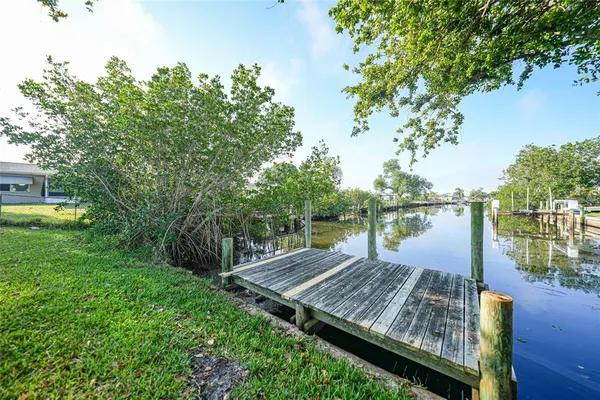 a view of a wooden deck with a lake view