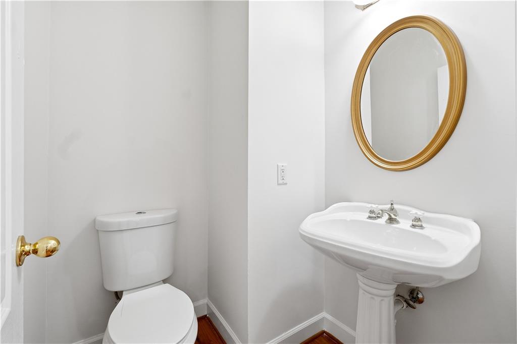 3051 Glenview Lane Monroe, GA 30656 - Photo 12 of 44 a bathroom with a toilet sink and mirror