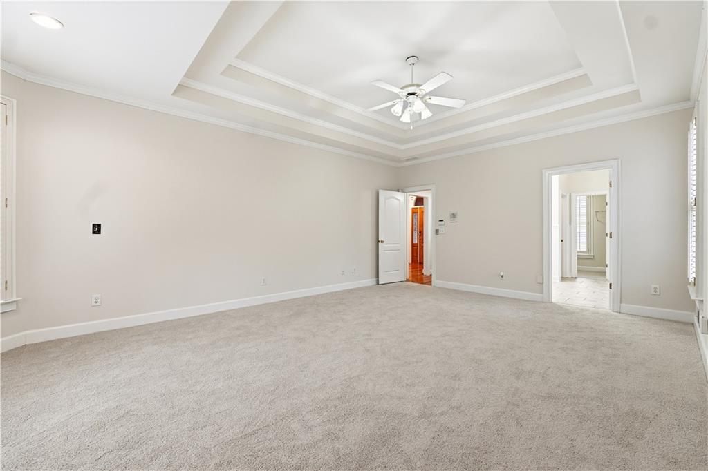 3051 Glenview Lane Monroe, GA 30656 - Photo 14 of 44 a view of an empty room with a chandelier fan