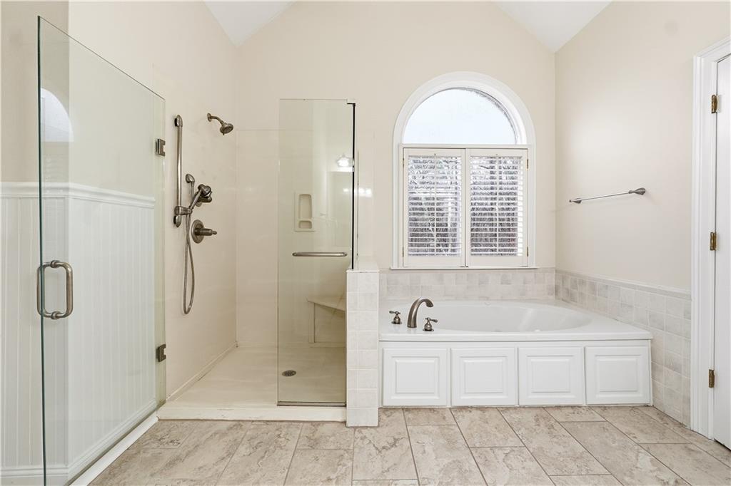3051 Glenview Lane Monroe, GA 30656 - Photo 17 of 44 a bathroom with a tub shower and sink