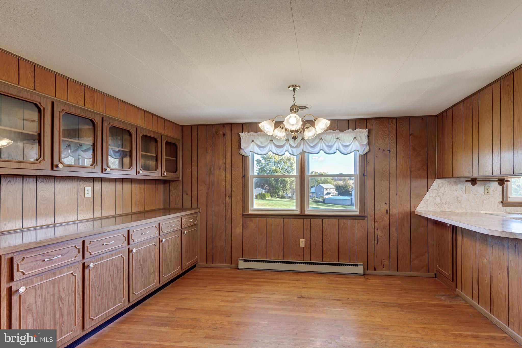 3830 Watson Lane Union Bridge, MD 21791 - Photo 9 of 37 a view of a kitchen with a sink dishwasher a kitchen island stainless steel appliances wooden floor and cabinets