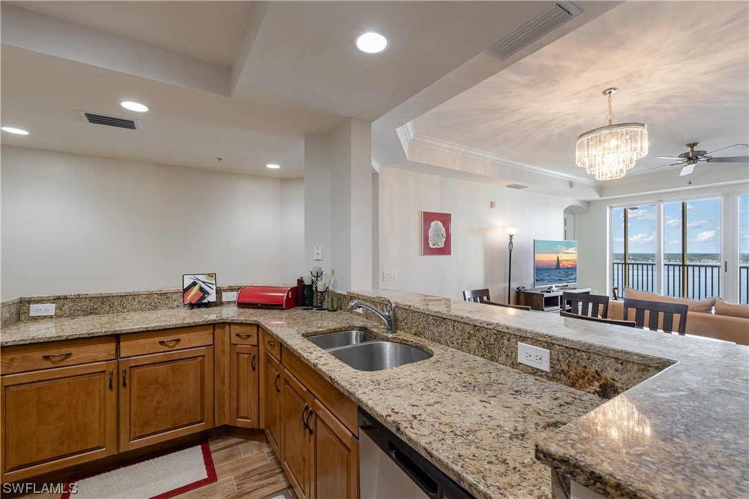 2743 First Street, Unit 1604 Fort Myers, FL 33916 - Photo 12 of 41 a kitchen with a sink a counter space appliances and cabinets