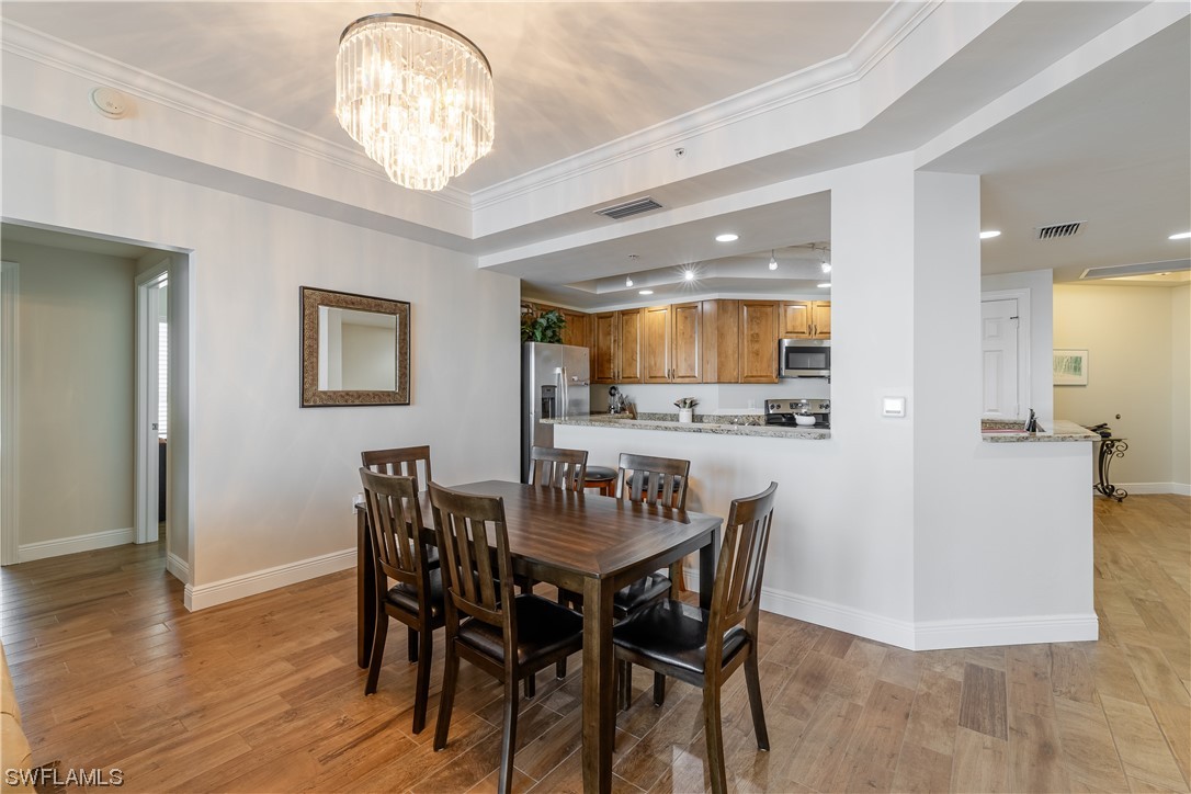 2743 First Street, Unit 1604 Fort Myers, FL 33916 - Photo 14 of 41 a view of a dining room with furniture and wooden floor