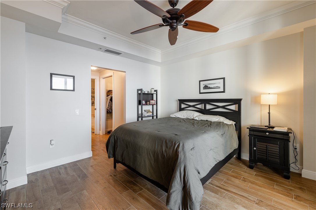 2743 First Street, Unit 1604 Fort Myers, FL 33916 - Photo 23 of 41 a bedroom with a bed and a lamp on dresser