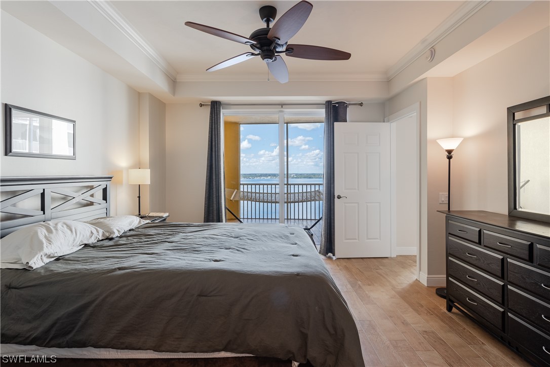 2743 First Street, Unit 1604 Fort Myers, FL 33916 - Photo 25 of 41 a bedroom with a bed and a chandelier