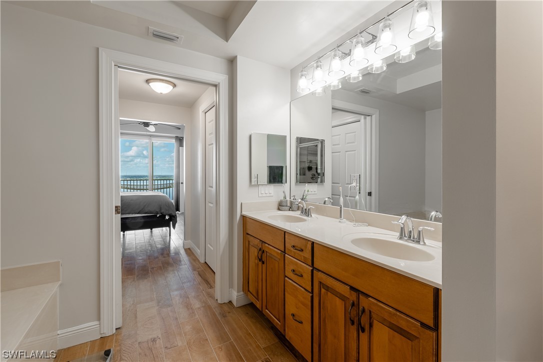 2743 First Street, Unit 1604 Fort Myers, FL 33916 - Photo 29 of 41 a spacious en suite bathroom with a double vanity sink and mirror