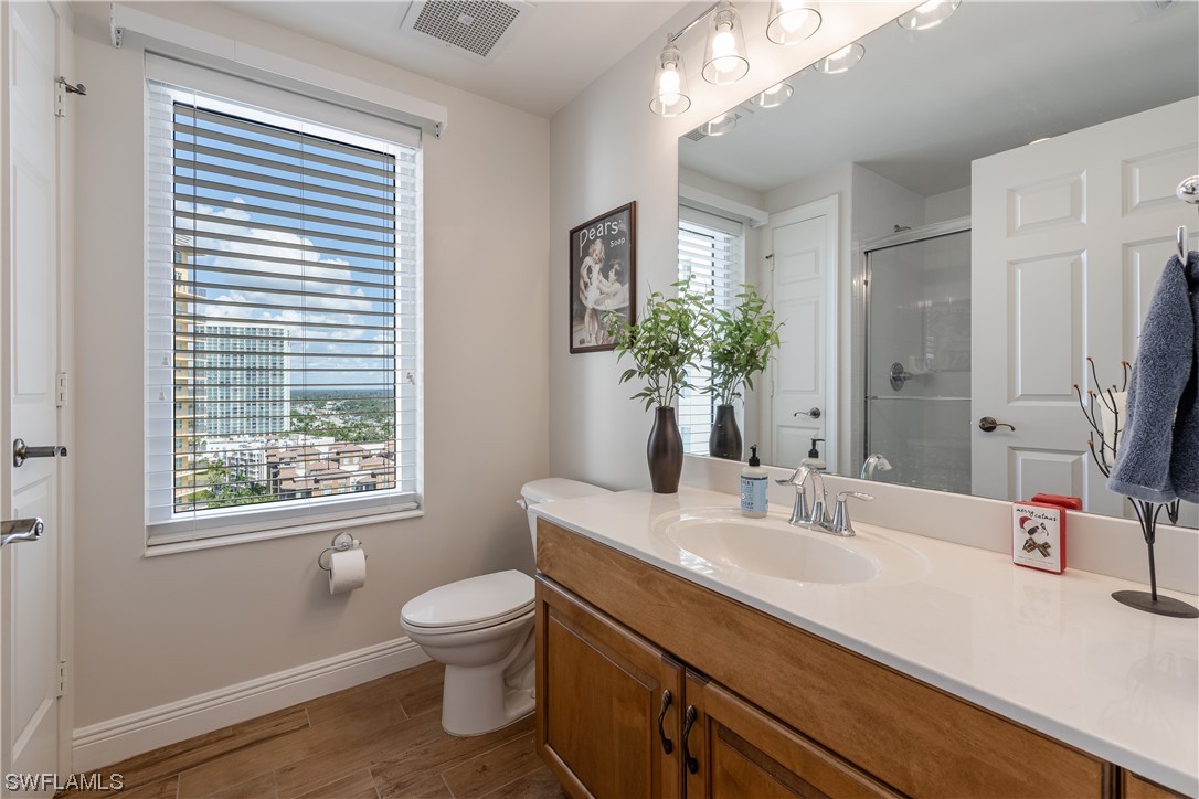 2743 First Street, Unit 1604 Fort Myers, FL 33916 - Photo 30 of 41 a bathroom with a sink a toilet and a mirror