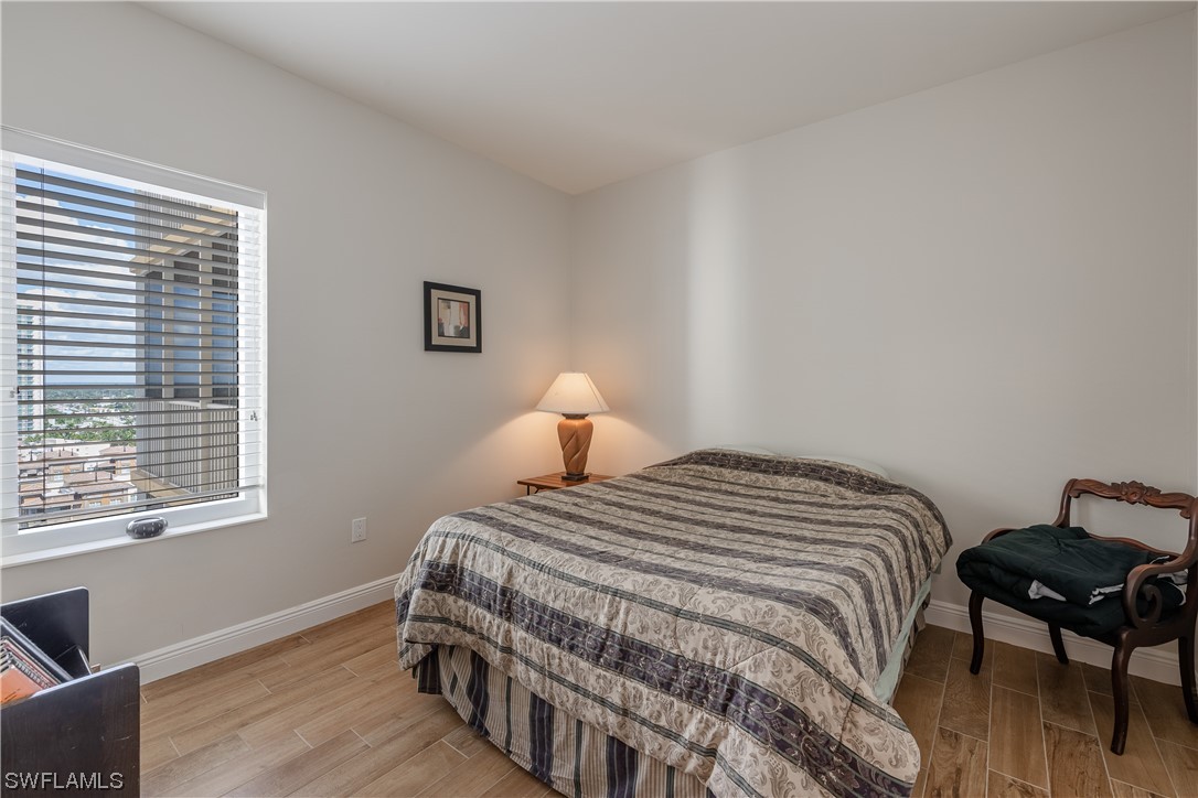 2743 First Street, Unit 1604 Fort Myers, FL 33916 - Photo 32 of 41 a bedroom with a bed and a window