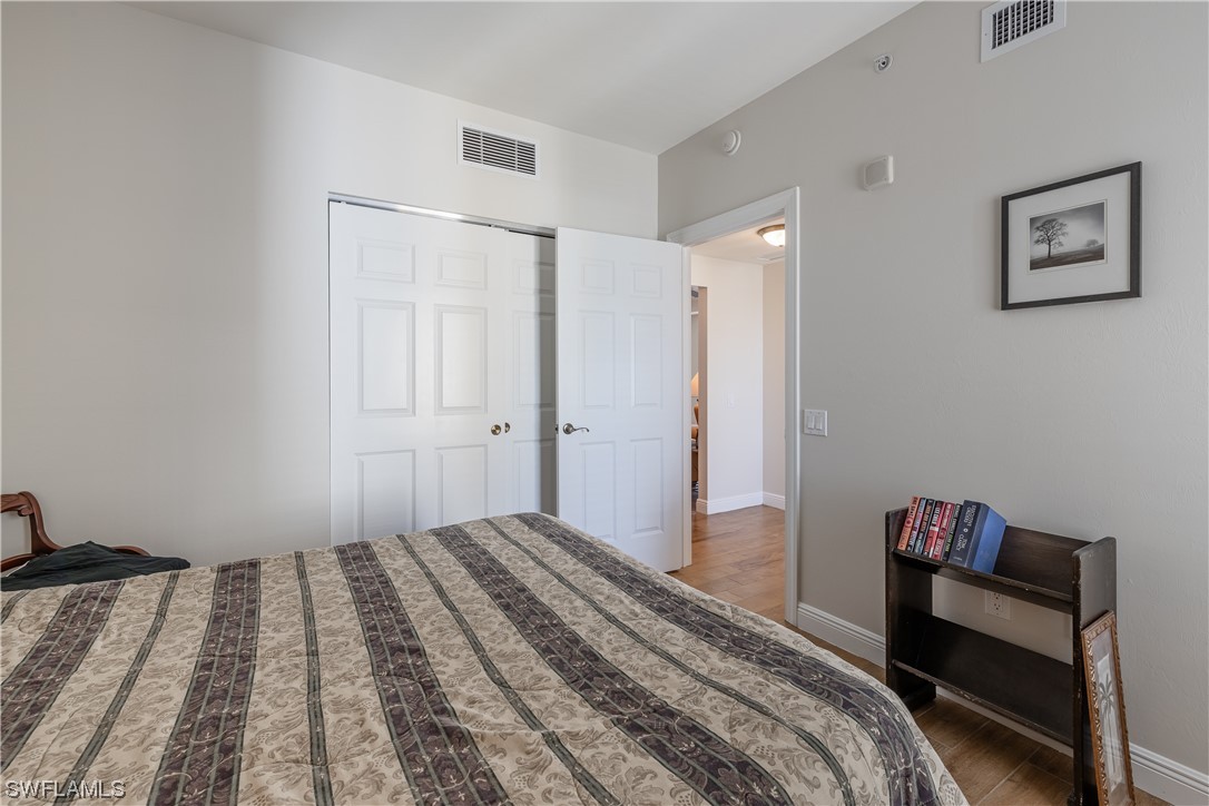2743 First Street, Unit 1604 Fort Myers, FL 33916 - Photo 33 of 41 a bedroom with a bed and a table