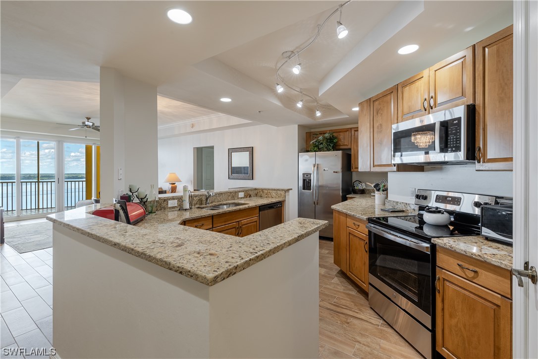 2743 First Street, Unit 1604 Fort Myers, FL 33916 - Photo 9 of 41 a kitchen with stainless steel appliances granite countertop a sink and stove