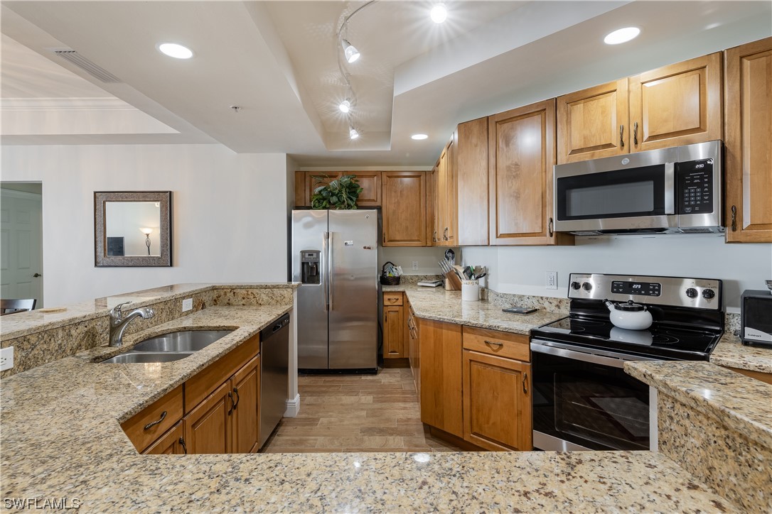 2743 First Street, Unit 1604 Fort Myers, FL 33916 - Photo 10 of 41 a kitchen with granite countertop a sink stove and refrigerator