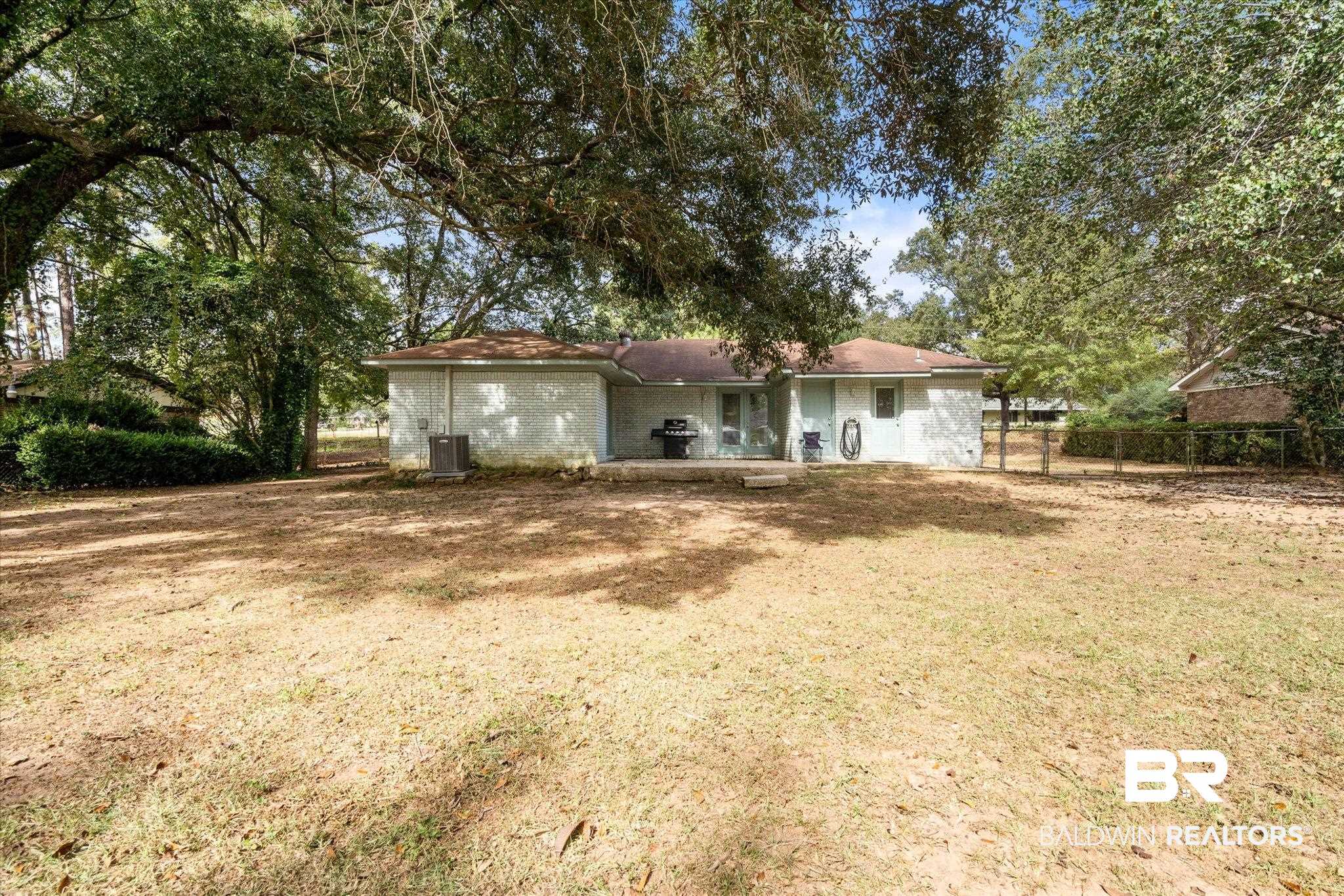 9987 Downing Street Semmes, AL 36575 - Photo 18 of 20 Back of house featuring a yard and cooling unit