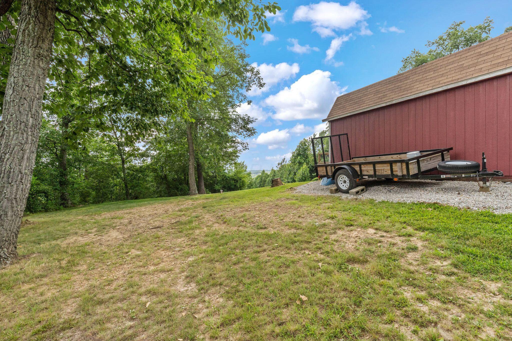 10446 Rich Hollow Road Southwest Lancaster, OH 43130 - Photo 76 of 83 Red-sided outbuilding with a brown shingle roof on a gravel foundation