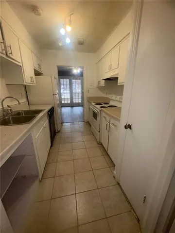 a kitchen with stainless steel appliances granite countertop a sink and cabinets
