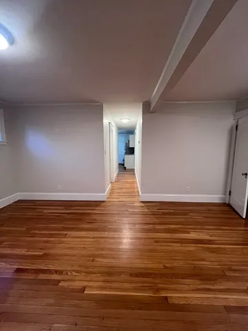 a view of a room with wooden floor