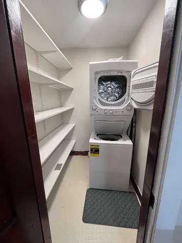a living room with a couch and a stove with wooden floor