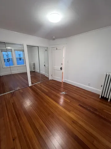 a view of a room with wooden floor