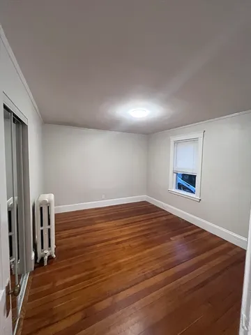 a view of room with wooden floor and window