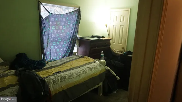 a bed sitting in a bedroom next to a window