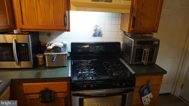 a kitchen with a stove and a cabinet
