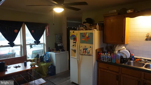 a kitchen with refrigerator and window