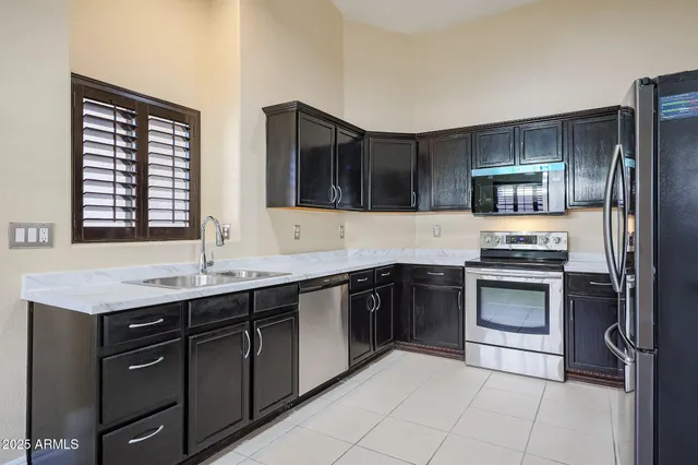 a kitchen with a sink stove and refrigerator