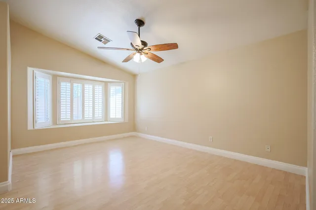 a view of room with hardwood floor and ceiling fan