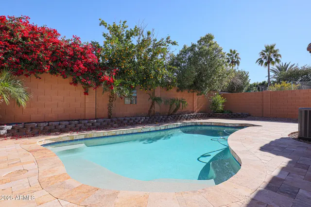a view of a swimming pool with a yard