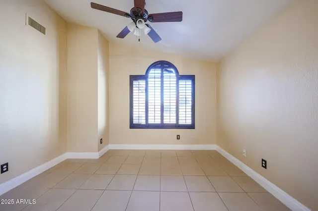 a view of entryway with a ceiling fan and a window