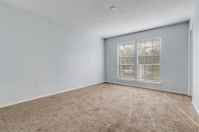 a bathroom with a sink a toilet and a large mirror