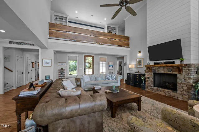 a large kitchen with stainless steel appliances kitchen island granite countertop a sink a counter space a stove and a refrigerator