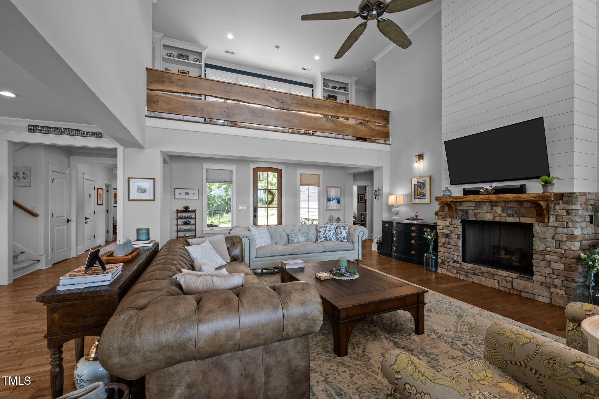 976 Estate Road Semora, NC 27343 - Photo 17 of 69 a living room with furniture a flat screen tv and a fireplace