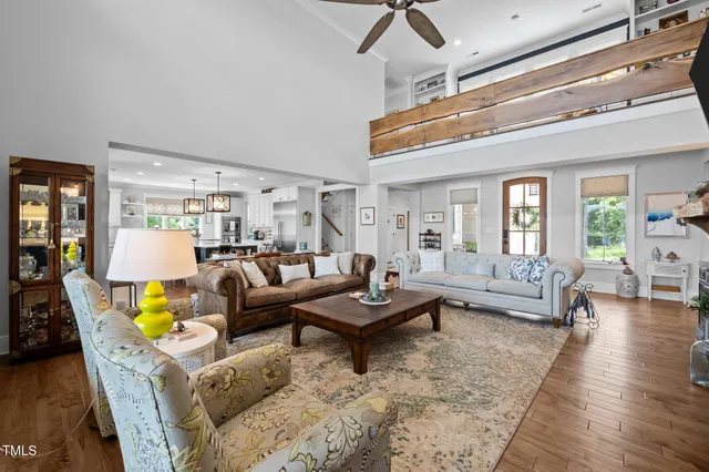 a kitchen with stainless steel appliances granite countertop wooden floors a stove and a sink