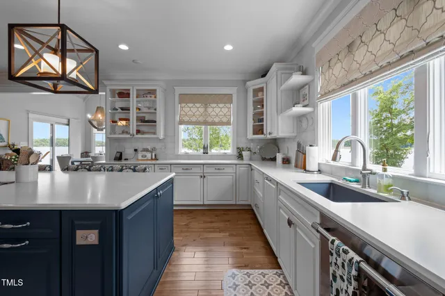 a kitchen with a sink cabinets and a stove top oven