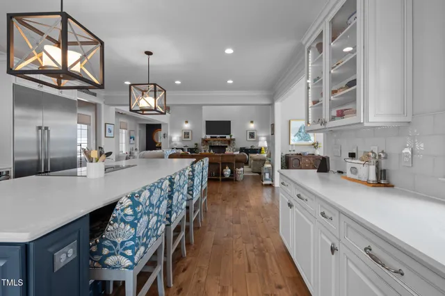 a dining room with furniture a chandelier and wooden floor