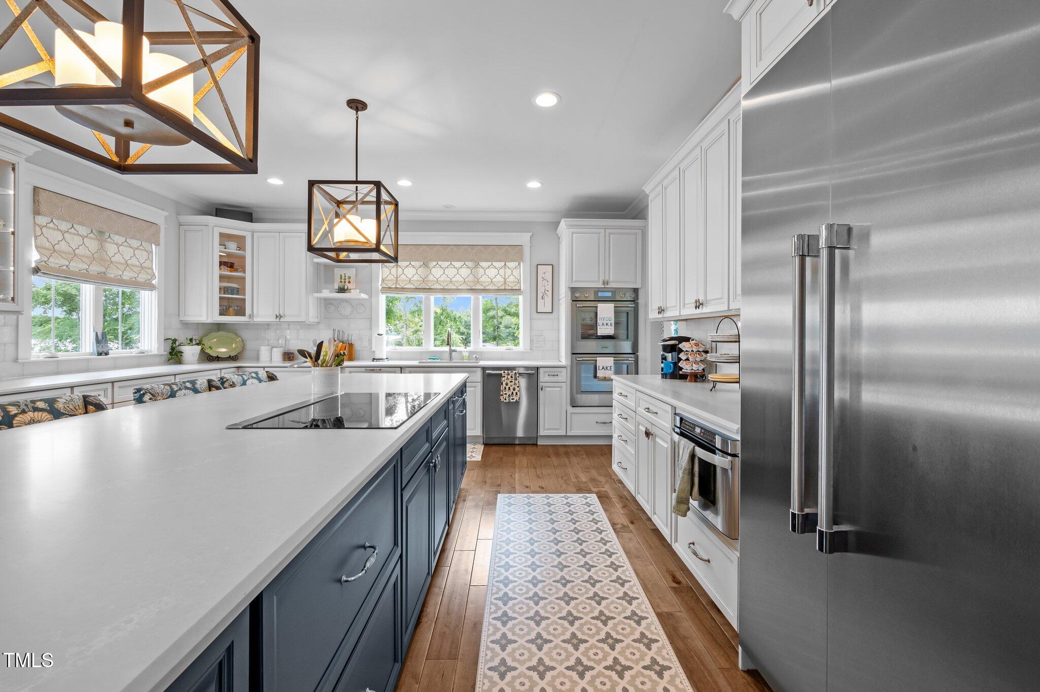 976 Estate Road Semora, NC 27343 - Photo 22 of 69 a large kitchen with stainless steel appliances kitchen island granite countertop a sink a counter space a stove and a refrigerator