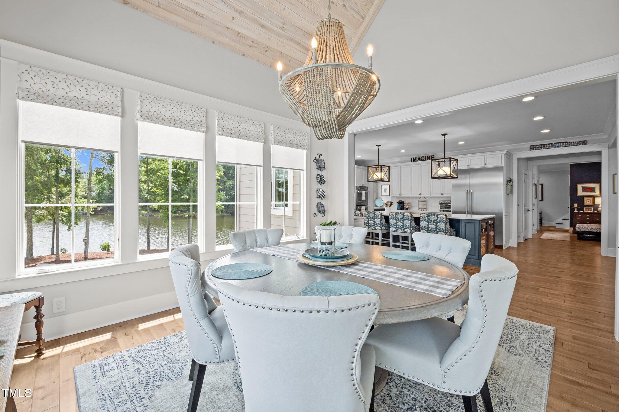 976 Estate Road Semora, NC 27343 - Photo 26 of 69 a dining room with furniture a chandelier and wooden floor