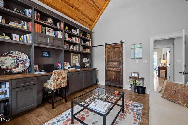 a view of a bedroom with furniture and wooden floor