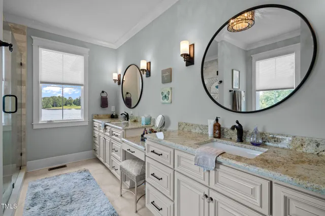 a bathroom with a sink toilet vanity and shower
