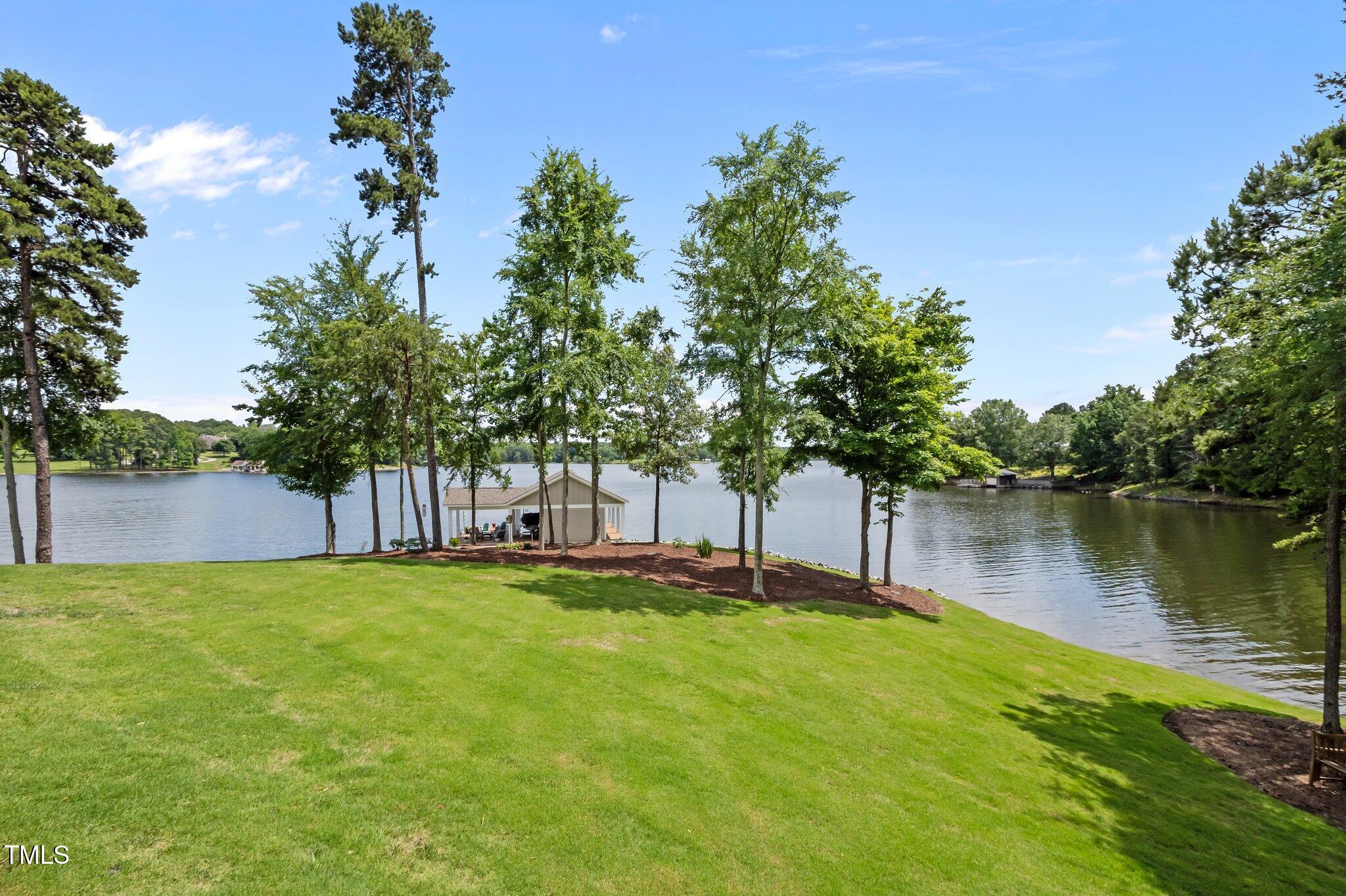 976 Estate Road Semora, NC 27343 - Photo 58 of 69 a view of a lake with a house in the background