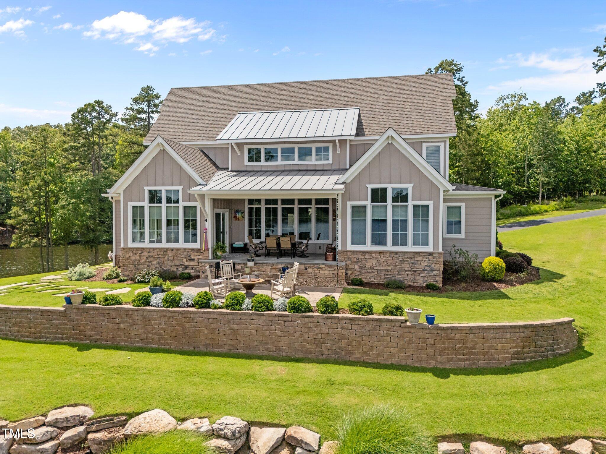 976 Estate Road Semora, NC 27343 - Photo 7 of 69 a front view of a house with a yard table and chairs