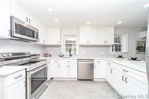 a kitchen with stainless steel appliances granite countertop a sink and stove top oven