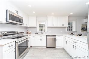 70 New Paltz Road, Unit 1B Highland, NY 12528 - Photo 2 of 7 a kitchen with stainless steel appliances granite countertop a sink and stove top oven