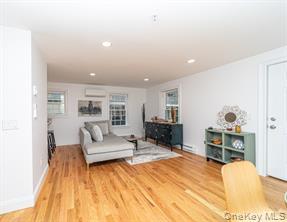 70 New Paltz Road, Unit 1B Highland, NY 12528 - Photo 4 of 7 a living room with furniture and a wooden floor