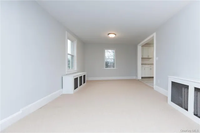 an empty room with windows and pillars in it