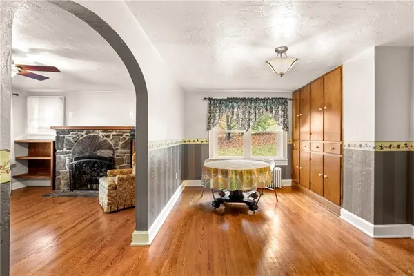 a view of a livingroom with furniture hardwood floor and a large window