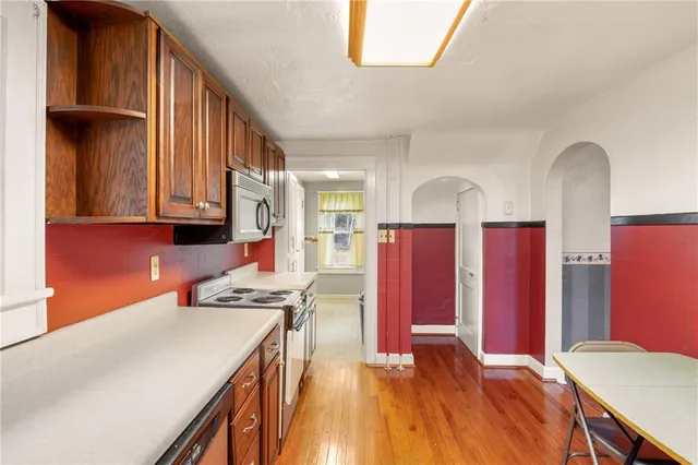a kitchen that has a lot of cabinets and refrigerator