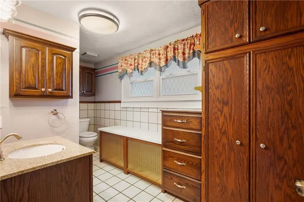 a kitchen with stainless steel appliances granite countertop a sink and cabinets with wooden floor