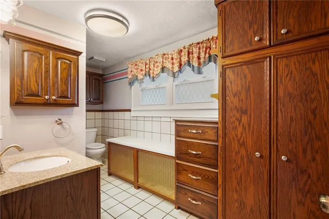 a kitchen with stainless steel appliances granite countertop a sink and cabinets with wooden floor
