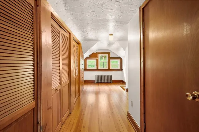 a view of a hallway view with wooden floor and staircase